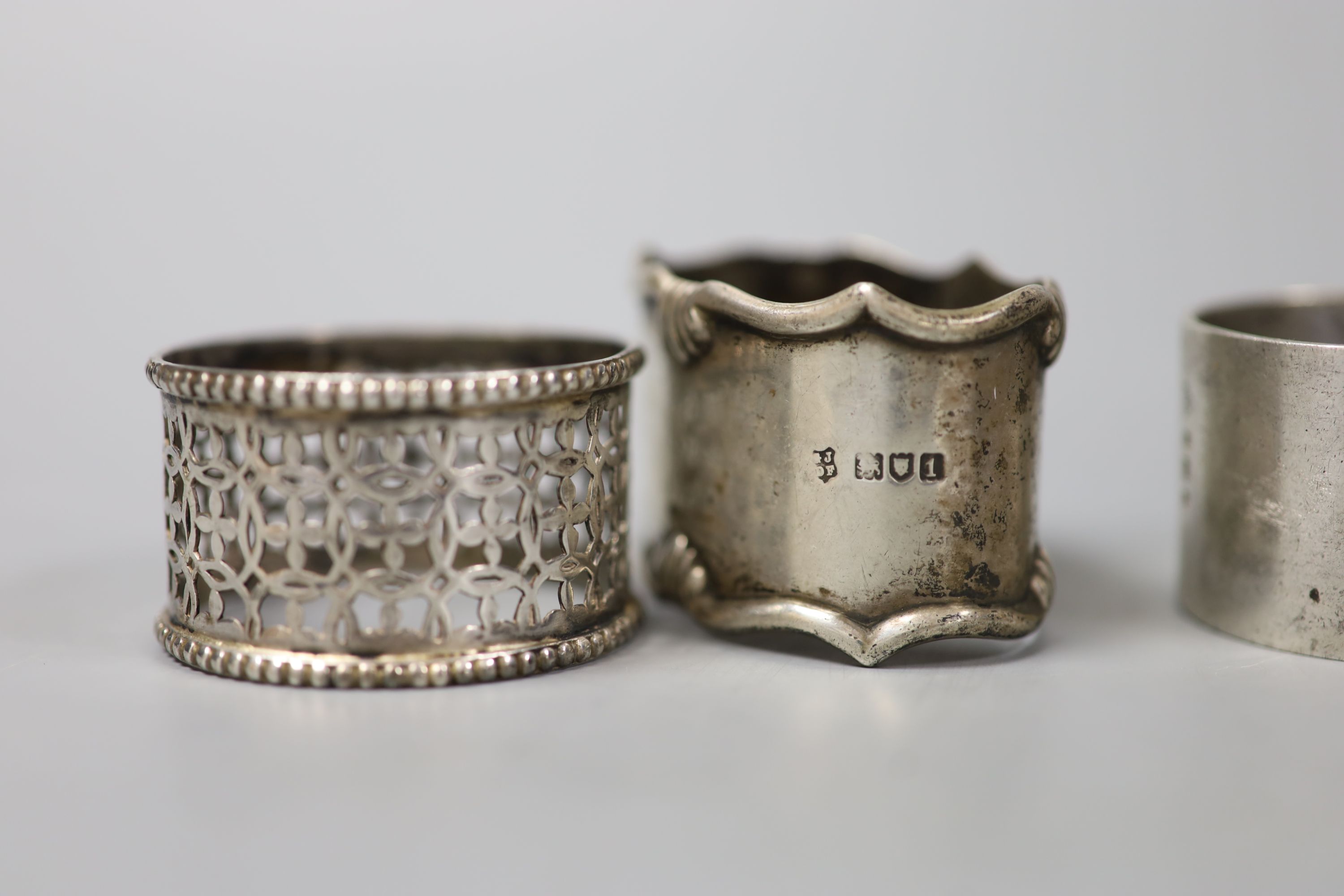 A pair of Edwardian silver napkin rings, London, 1906, three others and four pierced silver bonbon dishes